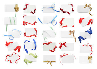 Blank cards with bright ribbons and bows isolated on white, top view