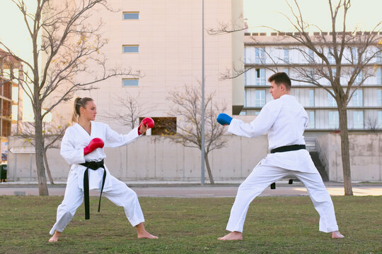 Karate fighters practicing outdoors in an urban setting