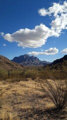 Fototapeta premium Majestic desert valley with vibrant clouds under a clear blue sky in a remote mountainous region