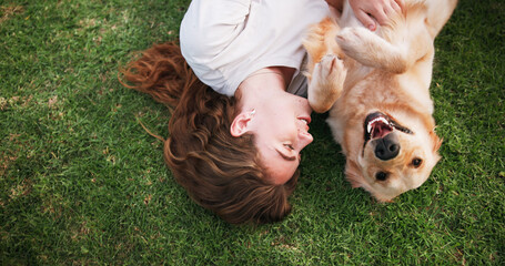 Woman, relax and lying with dog above on grass field for bonding, love and support at park. Top...