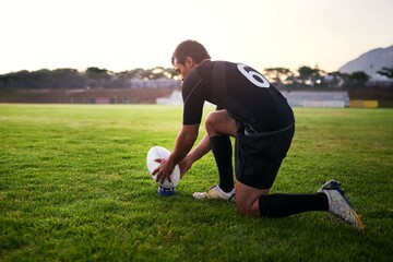 Rugby, man and player with ball, outdoor and performance for practice, game and fitness for athlete. Playground, grass and professional with strength, match and training for football and person