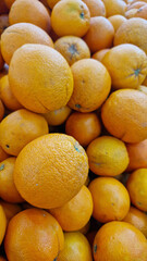 Oranges for sale in a supermarket. Citrus fruits, close-up with selective focus. Oranges in a store. Ripe, juicy, bright orange fruits. Fruits enriched with vitamin C