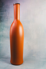 Tall Opaque Brown Glass Bottle with a Narrow Neck on a Textured Gray Background