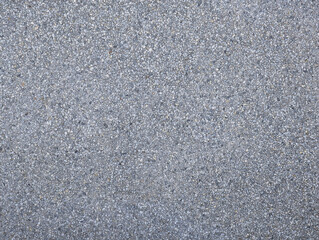 Grey concrete and small gravel stone wall texture. Gray hard surface with small stones background for house walls, plot division, facade. Architectural outdoor decoration. 