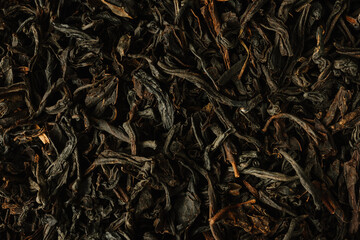 Dry black tea leaves.
