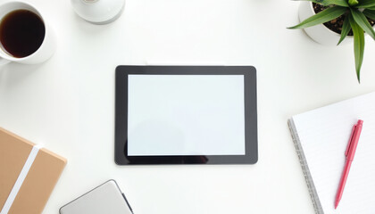 Blank Tablet on white desk with coffee and stationery.
