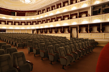 Rows of gray comfortable seats in theatre