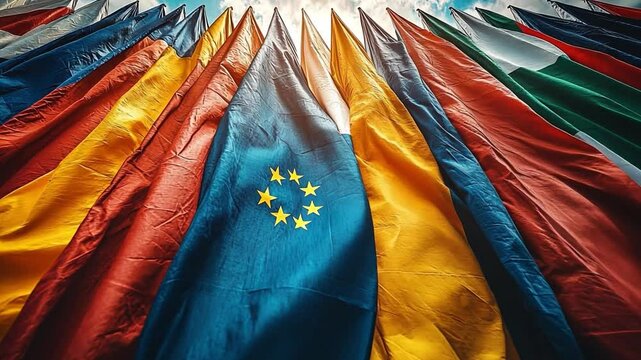 Flags of Unity: A vibrant tapestry of international flags flutter in the wind, creating a powerful visual metaphor for global cooperation, unity, and interconnectedness. The flags sway harmoniously.