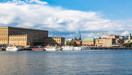 Stockholm, Sweden - 1 October 2022: Gamla Stan, old town in Stockholm at sunset with Riddarholmskyrkan church and boats