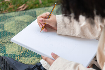 Outdoor sketching on canvas with pencil in natural light