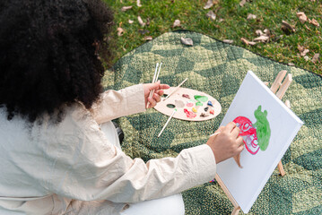 Outdoor creativity captured, young artist painting in the park