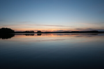 A calm, tranquil lake on a spring night in the forests of Finland