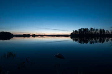 A calm, tranquil lake on a spring night in the forests of Finland