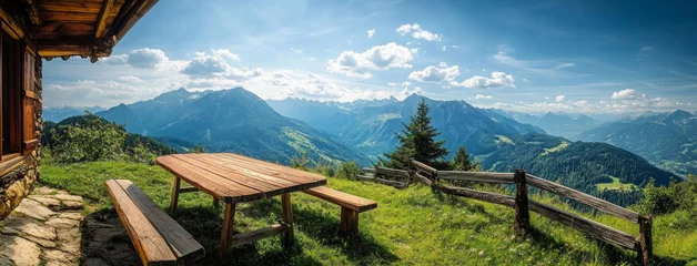 Selbstklebende Fototapeten Wooden picnic table inviting hikers to enjoy breathtaking mountain view © BRH