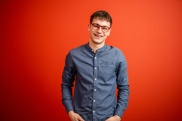 Obraz premium portrait of man stand in front red background studio shot