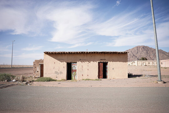 A traditional Saudi mud-house with two rustic doorways, weathered walls, and a flat wooden roof. This abandoned rural structure reflects authentic desert architecture and the heritage of old Saudi vil