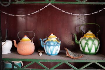 Vintage Saudi Arabian teapots on a rustic shelf, representing traditional hospitality and culture. A nostalgic touch of history, ideal for Saudi Founding Day, heritage storytelling, and ad backgrounds