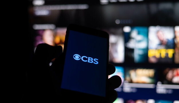 CBS logo is displayed on smartphone.
