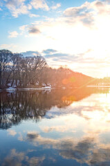 Fototapeta premium Beautiful lake with a bright sun reflecting on the water