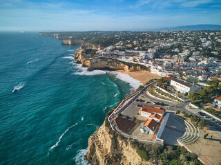 Aerial view of the Carvoeiro town and Catholic church on top of a cliff. Algarve, Portugal