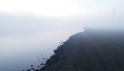 Fototapeta premium Misty Morning Shoreline Pebbles And Fog