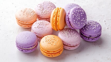 Fototapeta premium Top view of macaroons in bold and pastel colors, scattered freely on a smooth white surface, creating a vibrant and inviting composition