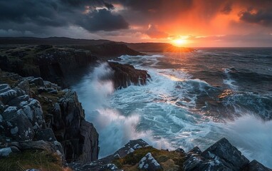 Obraz premium A dramatic sunset over a rocky coastline with crashing waves