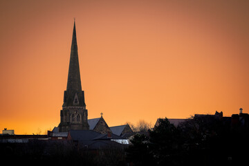 church steeple with sunset behind