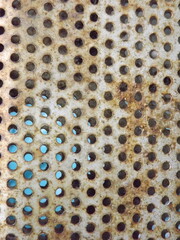 Rusty perforated metal surface texture