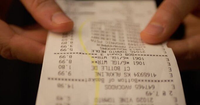 Inflation, Personal Finance, and Smart Spending. Till Slip Woman Holding Finance Document After Buying or Shopping in Supermarket. Slow motion.