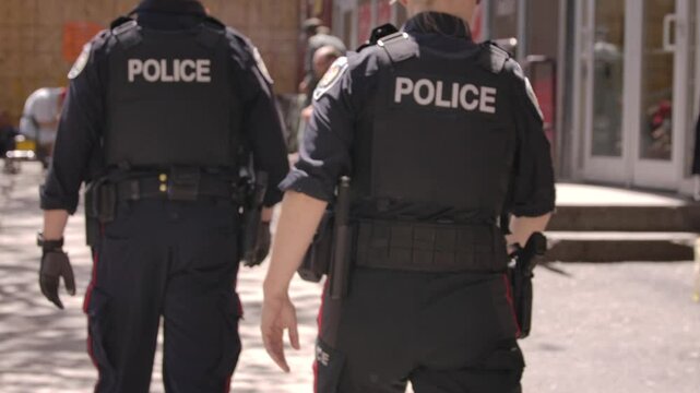 Police walking through homeless encampment