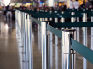 Stanchions with retractable belts for crowd control in a busy airport terminal area