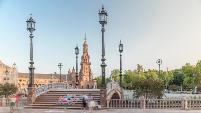 Plaza de Espana in Seville timelapse hyperlapse, a grand architectural complex in Maria Luisa Park built for the Ibero-American Exposition. Bridge with tourists, canal and vintage streetlights