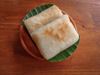 Jadah bakar or baked sticky rice cake, Indonesian or Javanese traditional cake made from sticky rice with grated coconut and grilled over charcoal. Usually served as a tea time 