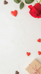 Fototapeta premium Romantic flat lay with red rose, hearts, and chocolates for special occasions
