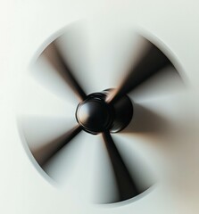 A dynamic image of a black ceiling fan rotating, embodying modern design and conveying a sense of movement and airflow in a minimalist space