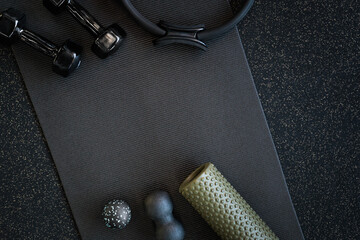 Sports massagers manual and electric in the gym on a mat of black color. 