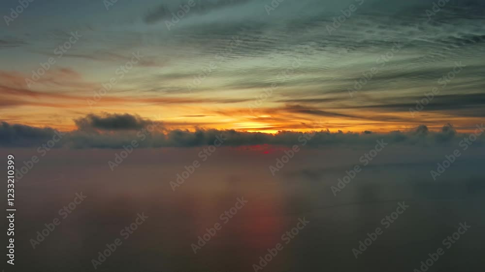 Wall mural aerial view of sea surface during a beautiful colourful sunset, timelapse, 4k