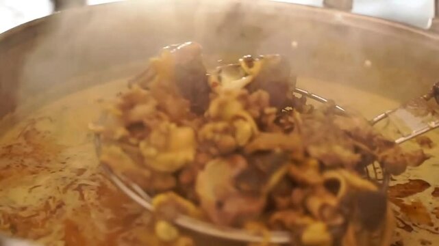 Close up view of soft goat meat soto tongseng soup in a large banner