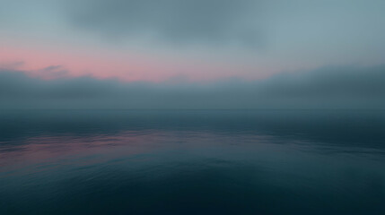 Obraz premium Misty sunrise over calm sea; peaceful dawn