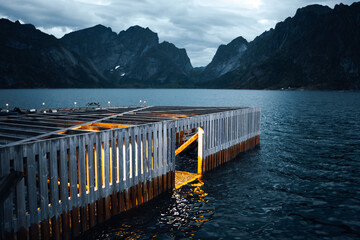 A picturesque scenic dock at twilight, beautifully framed by a stunning mountain backdrop