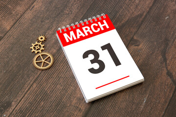 March 31st. Image of march 31 wooden color calendar on white background.