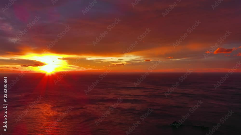 Wall mural aerial view of sea surface during a dramatic red sunset, timelapse, 4k