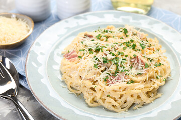 Delicious pasta Carbonara with bacon served on table, closeup