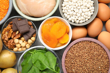 Different products rich in iron on grey table, top view. Diet plan for anemia