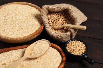 Oat bran and grains on wooden table, closeup