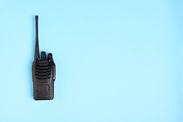 One walkie talkie on light blue background, top view. Space for text