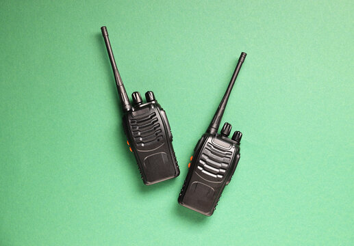 Walkie talkies on green background, top view - Powered by Adobe