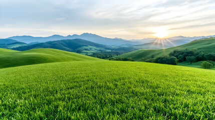 Obraz premium Sunrise over rolling green hills and mountains. Peaceful landscape for travel brochures
