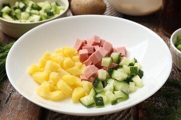 Different ingredients for okroshka soup on wooden table, closeup